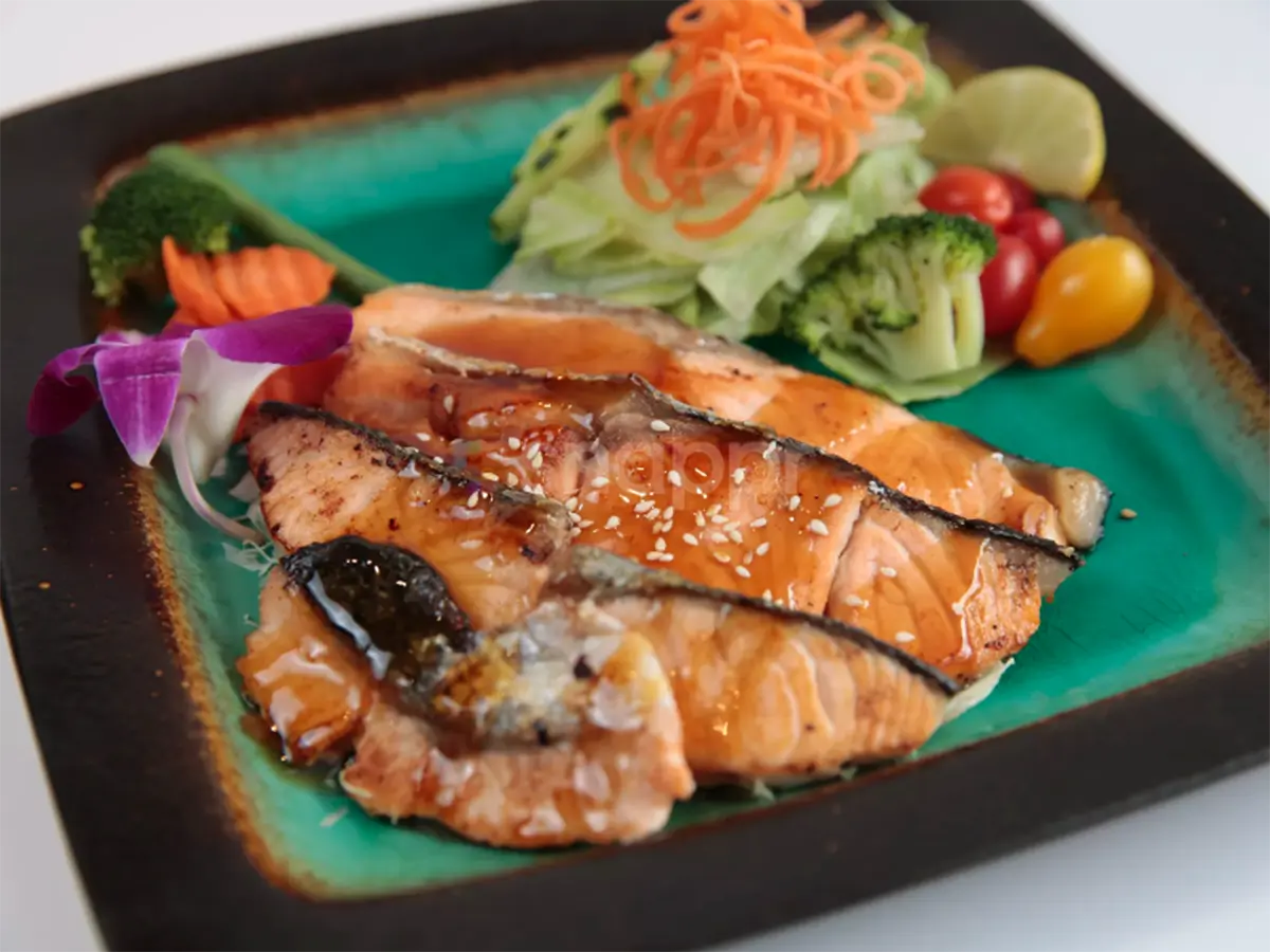 Kitchen-Aloha-Japanese-restaurant-Grilled-Salmon-Teriyaki-San-Francisco Grilled salmon teriyaki with sesame seeds, served with fresh salad, vegetables, and lemon at Kitchen Aloha Japanese restaurant in San Francisco